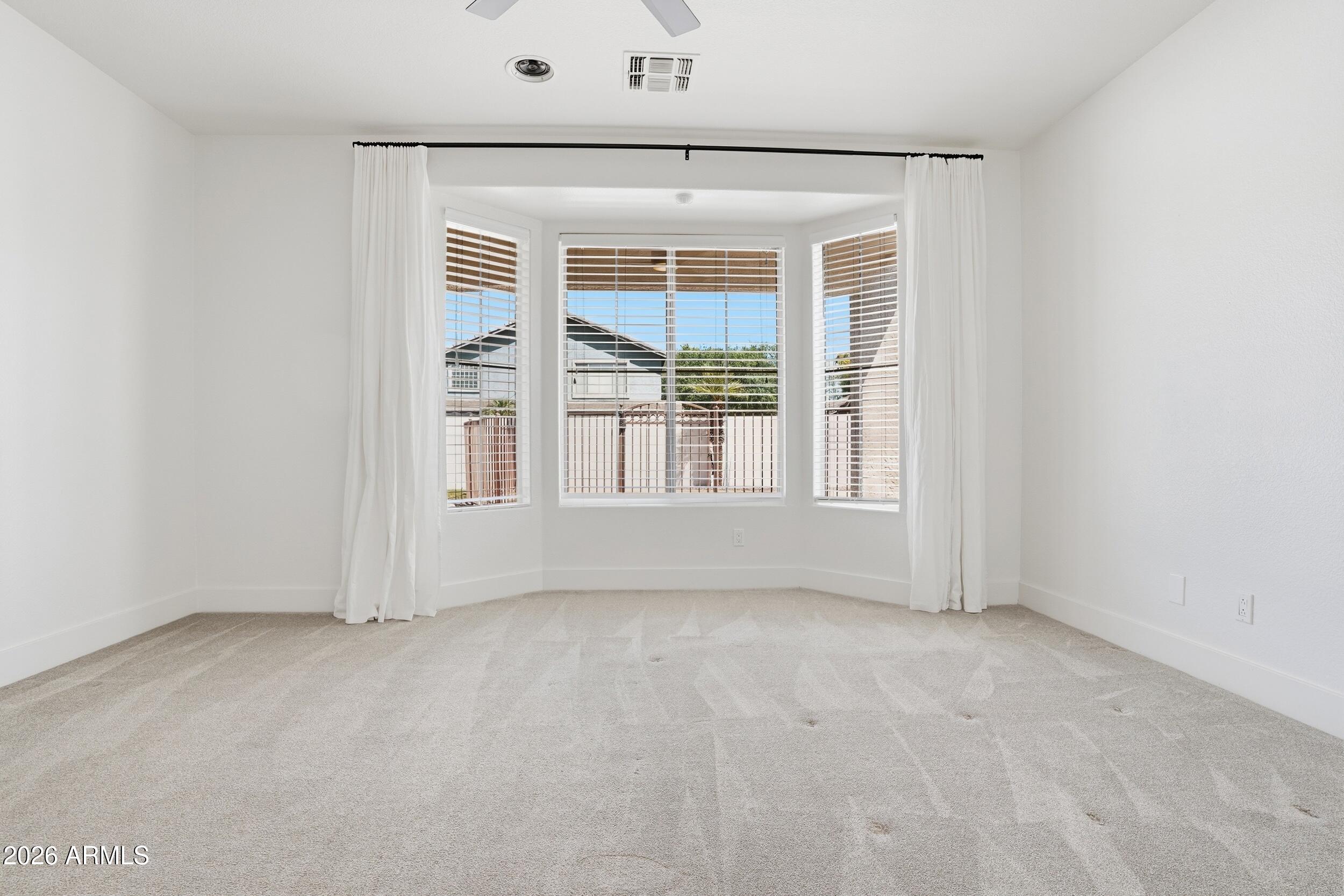 3262 East Cotton Lane Gilbert, AZ 85234 - Photo 19 of 53 an empty room with a window
