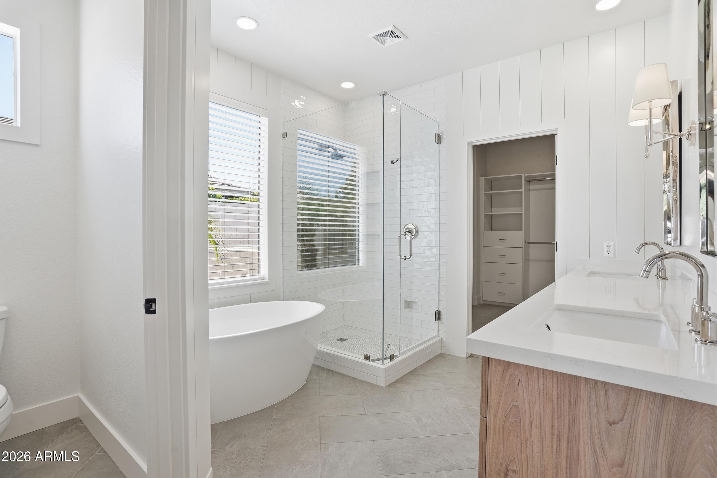 3262 East Cotton Lane Gilbert, AZ 85234 - Photo 22 of 53 a bathroom with a tub sink and mirror