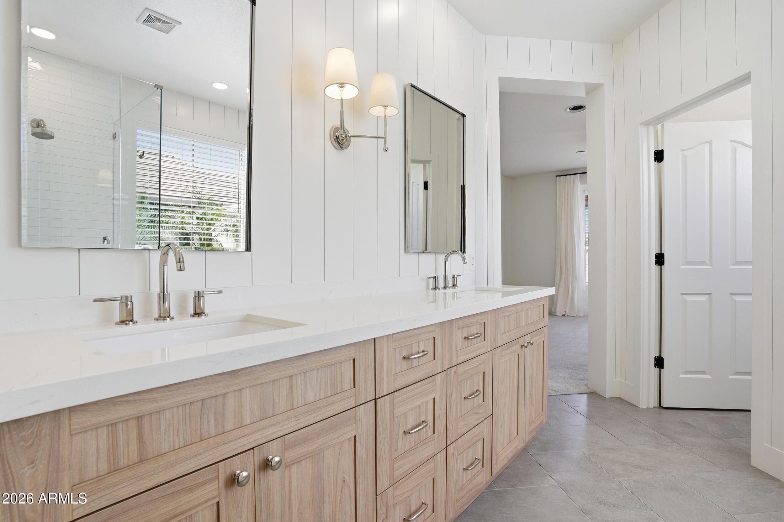 3262 East Cotton Lane Gilbert, AZ 85234 - Photo 23 of 53 a bathroom with double vanity sink a mirror and a shower