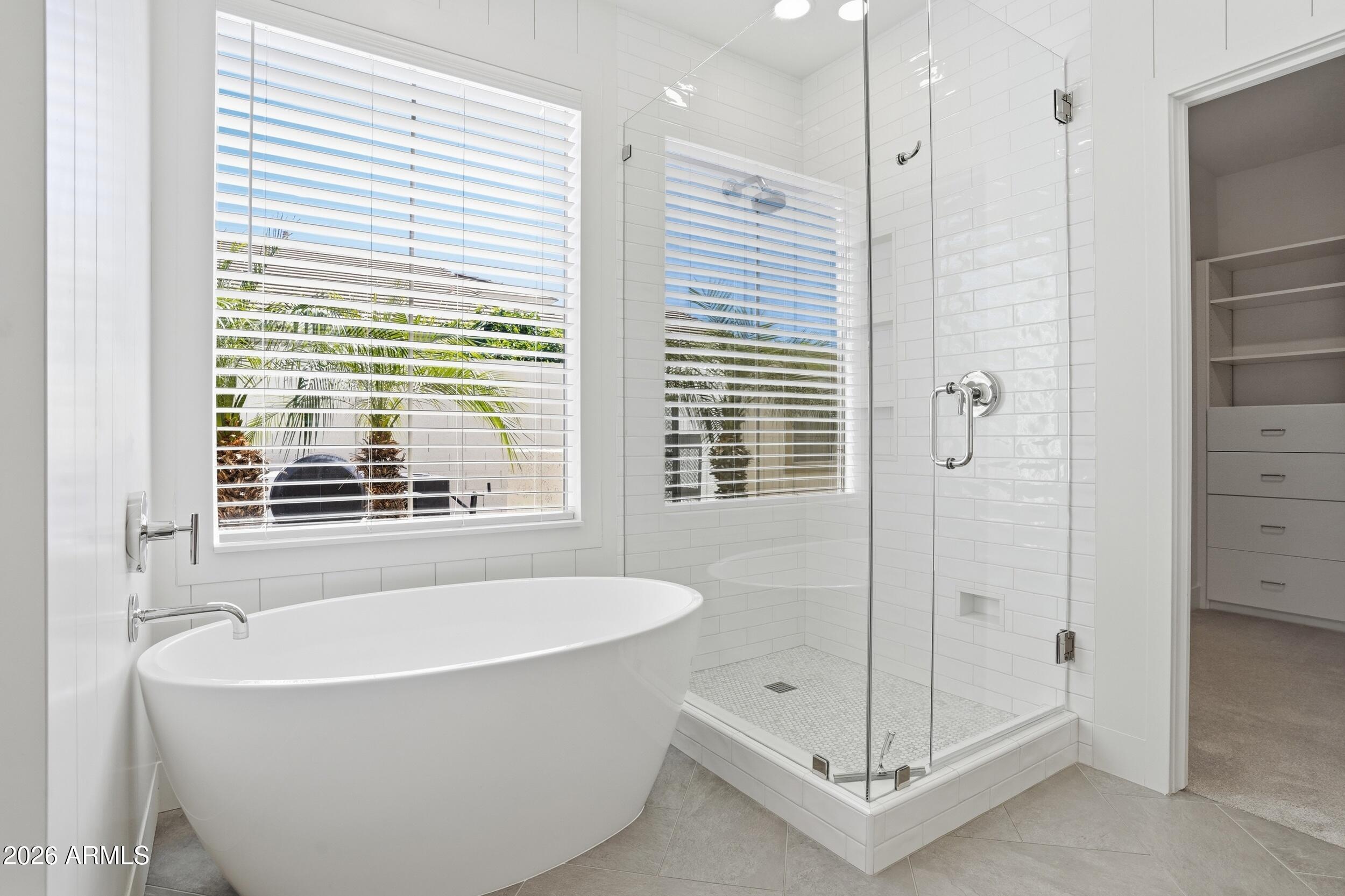 3262 East Cotton Lane Gilbert, AZ 85234 - Photo 24 of 53 a bathroom with a bathtub and a shower