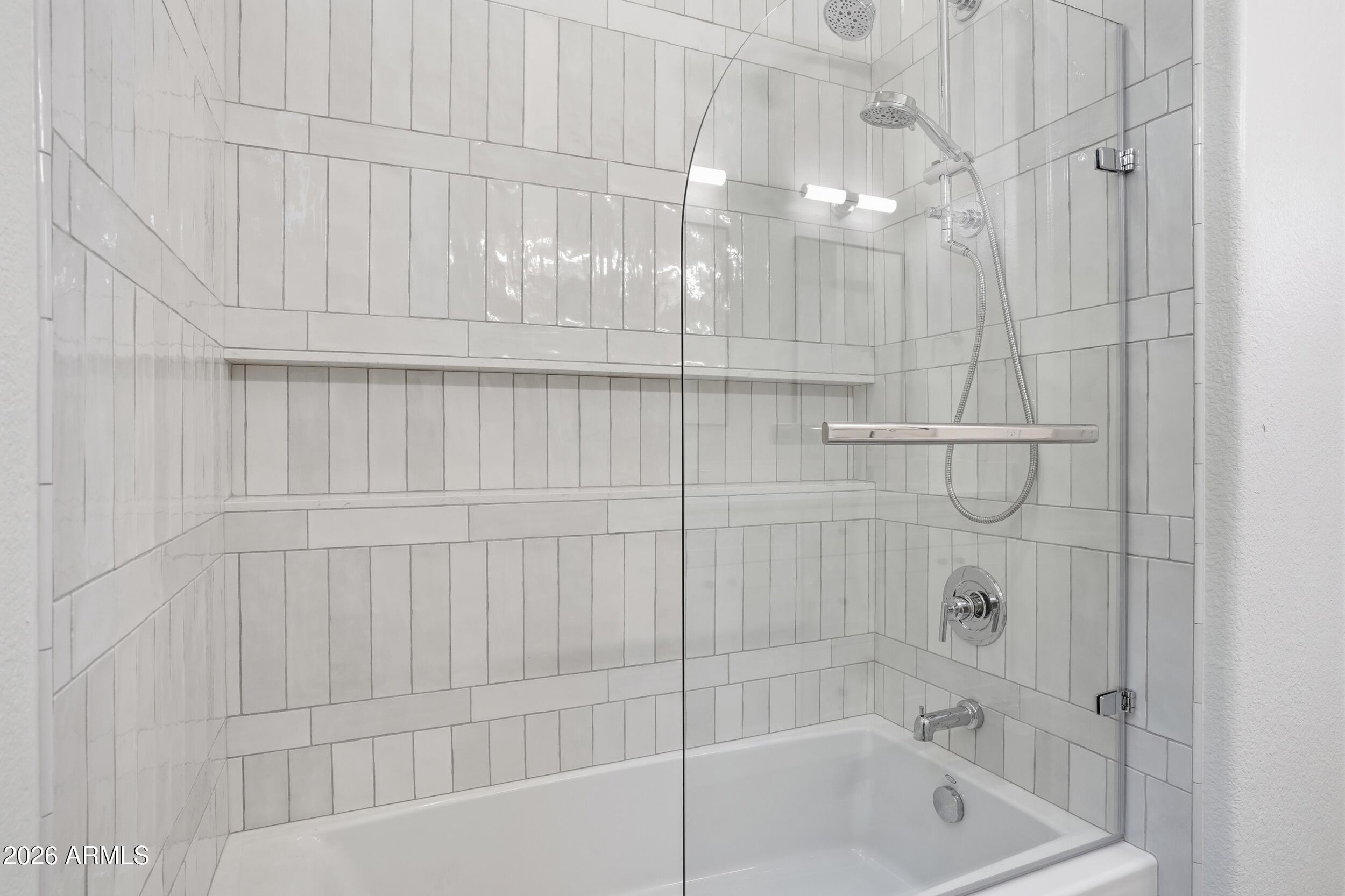 3262 East Cotton Lane Gilbert, AZ 85234 - Photo 32 of 53 a bathroom with a bathtub and shower
