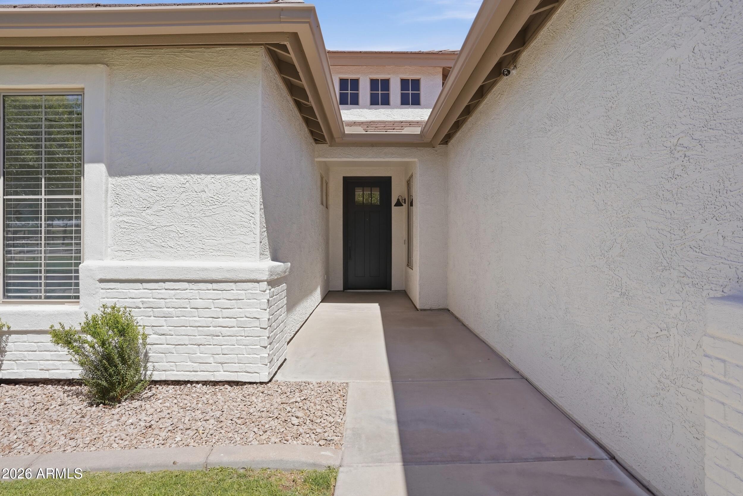 3262 East Cotton Lane Gilbert, AZ 85234 - Photo 4 of 53 a front view of a house with a yard