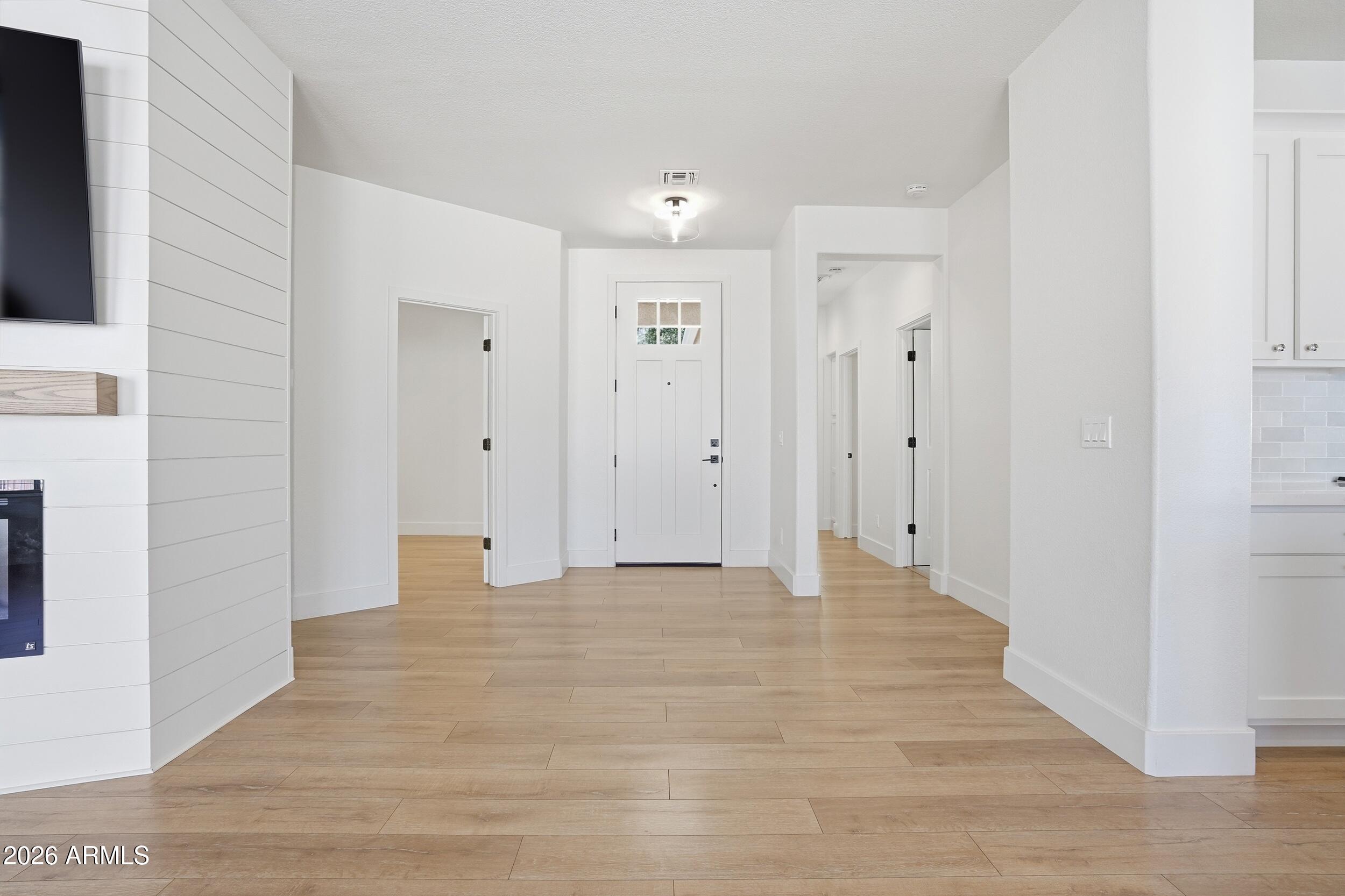 3262 East Cotton Lane Gilbert, AZ 85234 - Photo 5 of 53 a view of an empty room with wooden floor