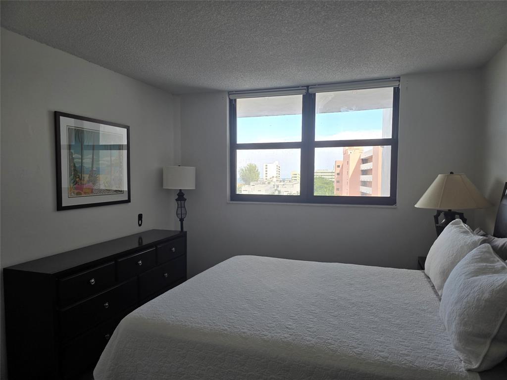 1401 North Riverside Drive, Unit 705 Pompano Beach, FL 33062 - Photo 12 of 30 a bedroom with a bed and a window