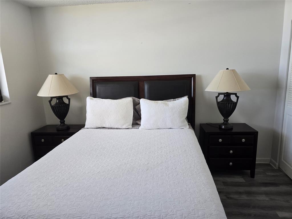 1401 North Riverside Drive, Unit 705 Pompano Beach, FL 33062 - Photo 14 of 30 a bedroom with a bed and a lamp