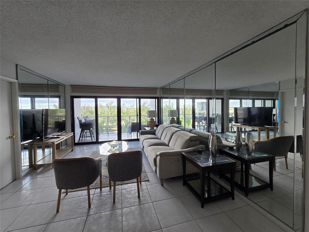 1401 North Riverside Drive, Unit 705 Pompano Beach, FL 33062 - Photo 2 of 30 a living room with furniture and a large window