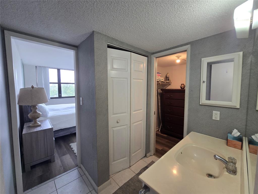 1401 North Riverside Drive, Unit 705 Pompano Beach, FL 33062 - Photo 9 of 30 a bathroom with a sink a toilet and shower