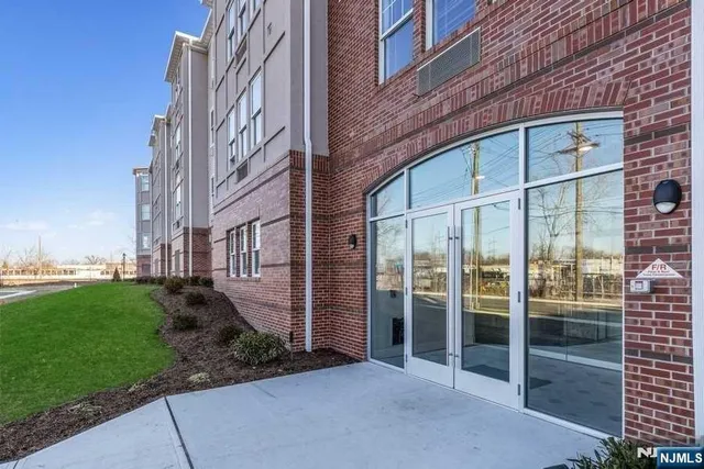 a view of a brick building next to a yard