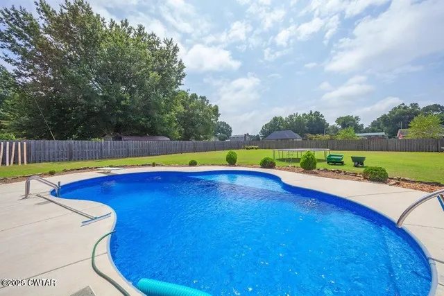 a view of a swimming pool with an outdoor seating and yard