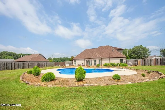 a view of a house with swimming pool and porch
