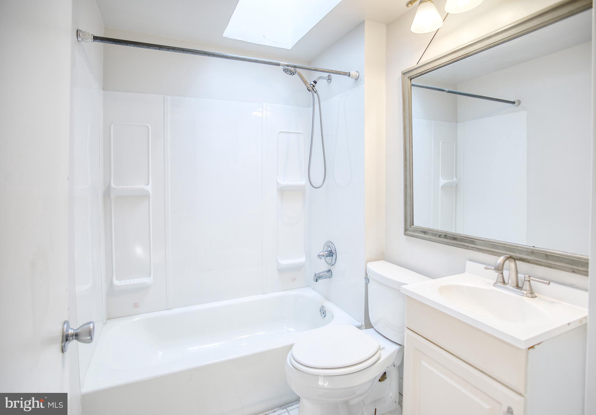 1332 Cambria Street Baltimore, MD 21225 - Photo 21 of 31 a bathroom with a sink toilet and shower