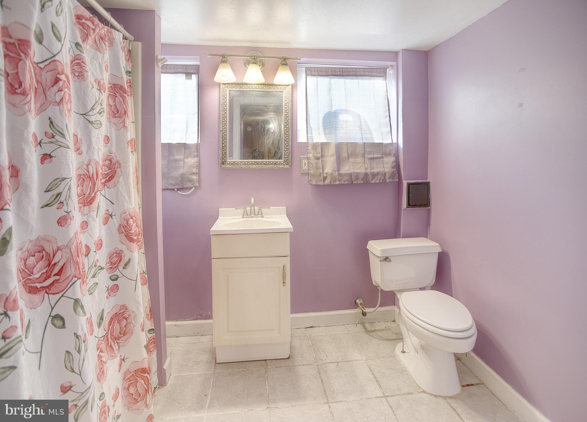 1332 Cambria Street Baltimore, MD 21225 - Photo 30 of 31 a white toilet sitting next to a bathroom sink
