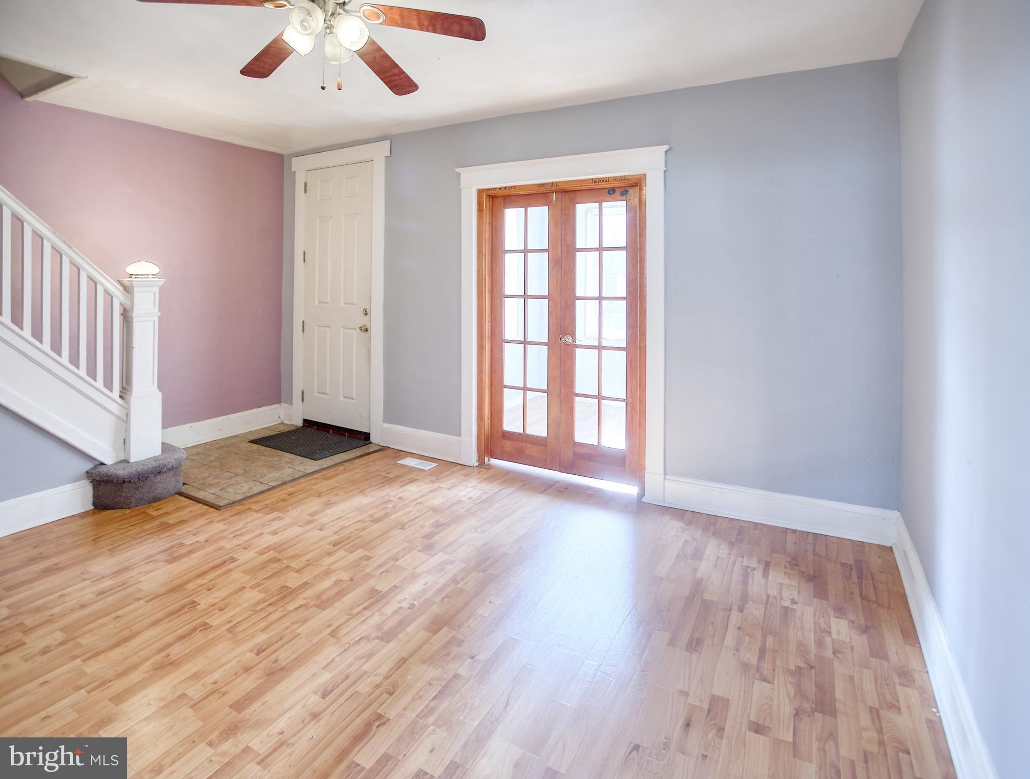 1332 Cambria Street Baltimore, MD 21225 - Photo 5 of 31 an empty room with wooden floor and windows
