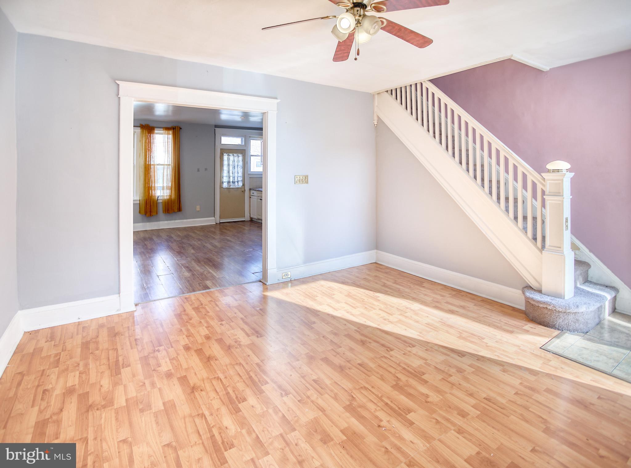 1332 Cambria Street Baltimore, MD 21225 - Photo 8 of 31 a view of an empty room with wooden floor and a chandelier fan