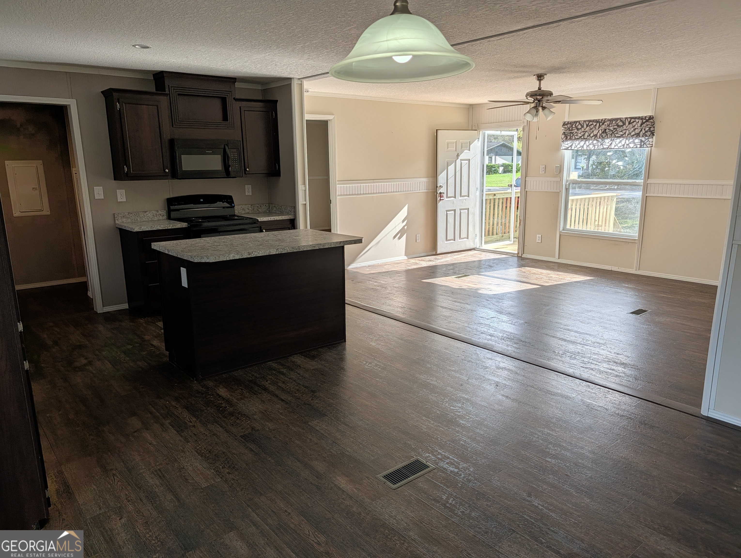 675 Fir Street Jesup, GA 31546 - Photo 11 of 22 an empty room with wooden floor and windows