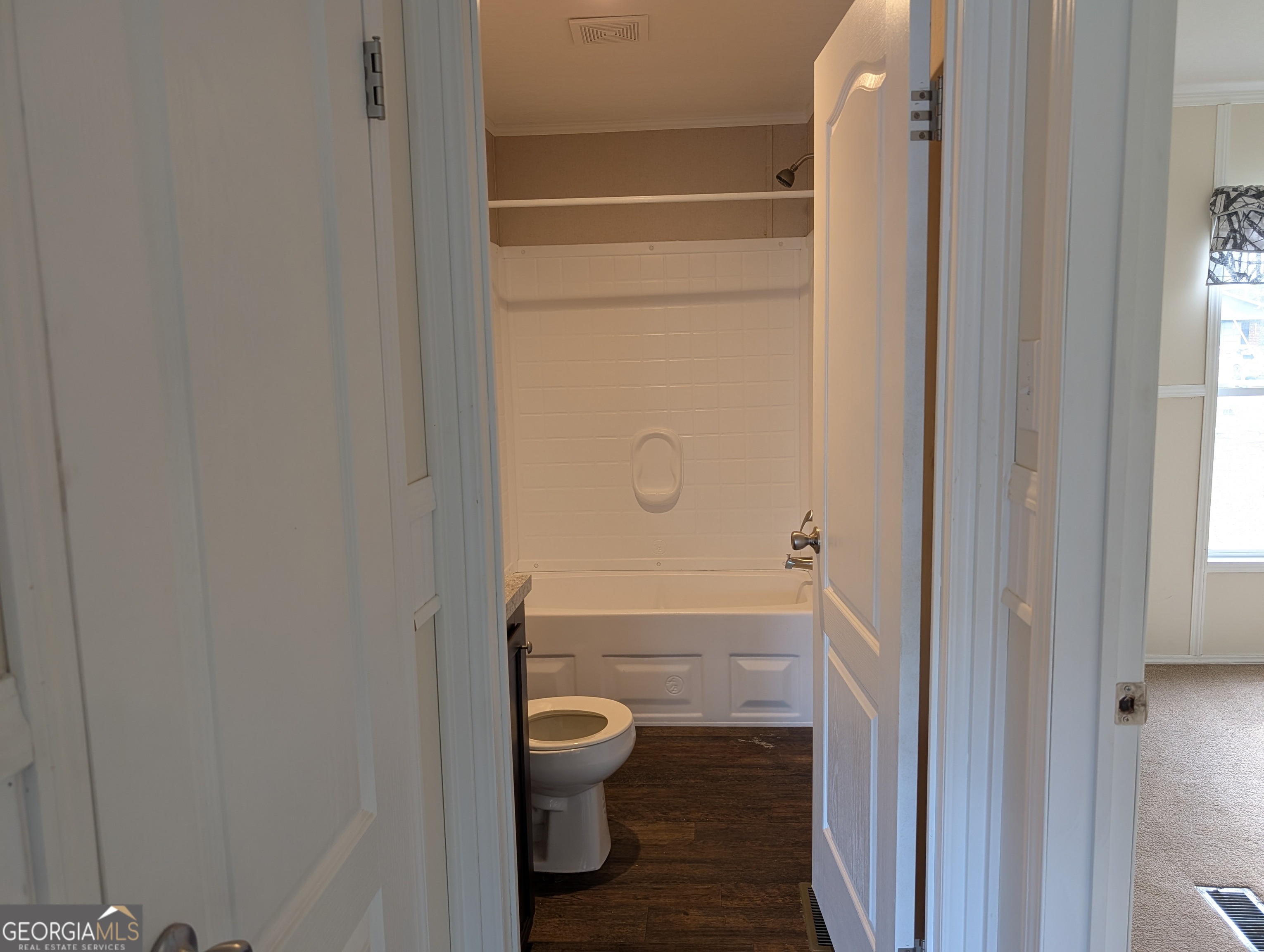 675 Fir Street Jesup, GA 31546 - Photo 17 of 22 a bathroom with a granite countertop toilet and a shower