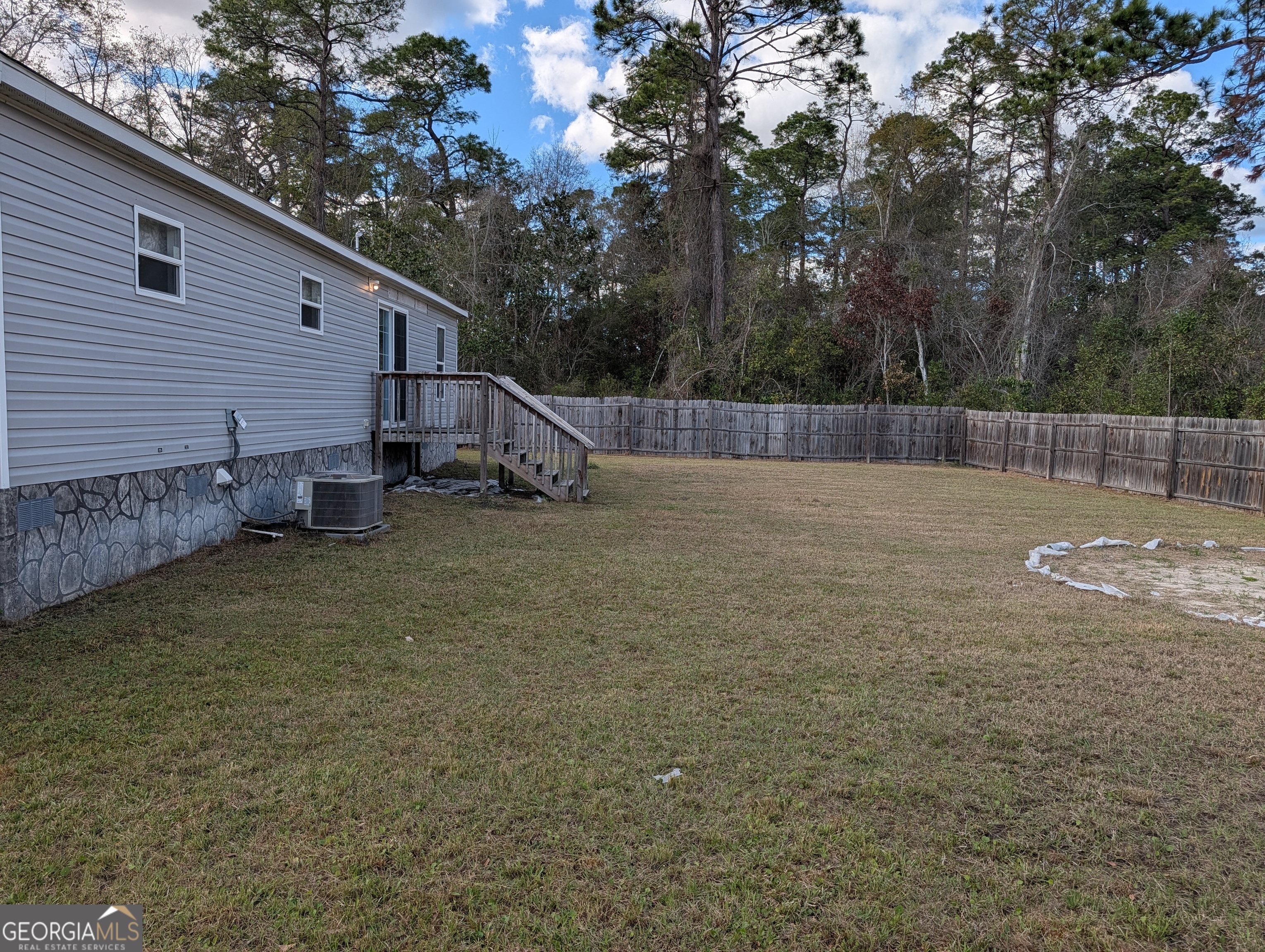675 Fir Street Jesup, GA 31546 - Photo 3 of 22 a backyard of a house with table and chairs