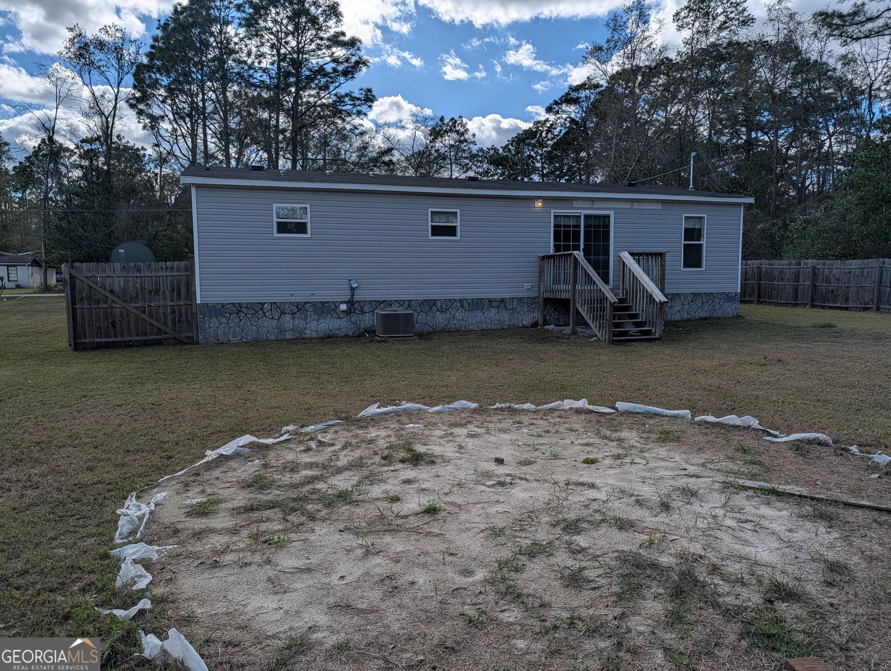 675 Fir Street Jesup, GA 31546 - Photo 6 of 22 a backyard of a house with barbeque oven and outdoor seating