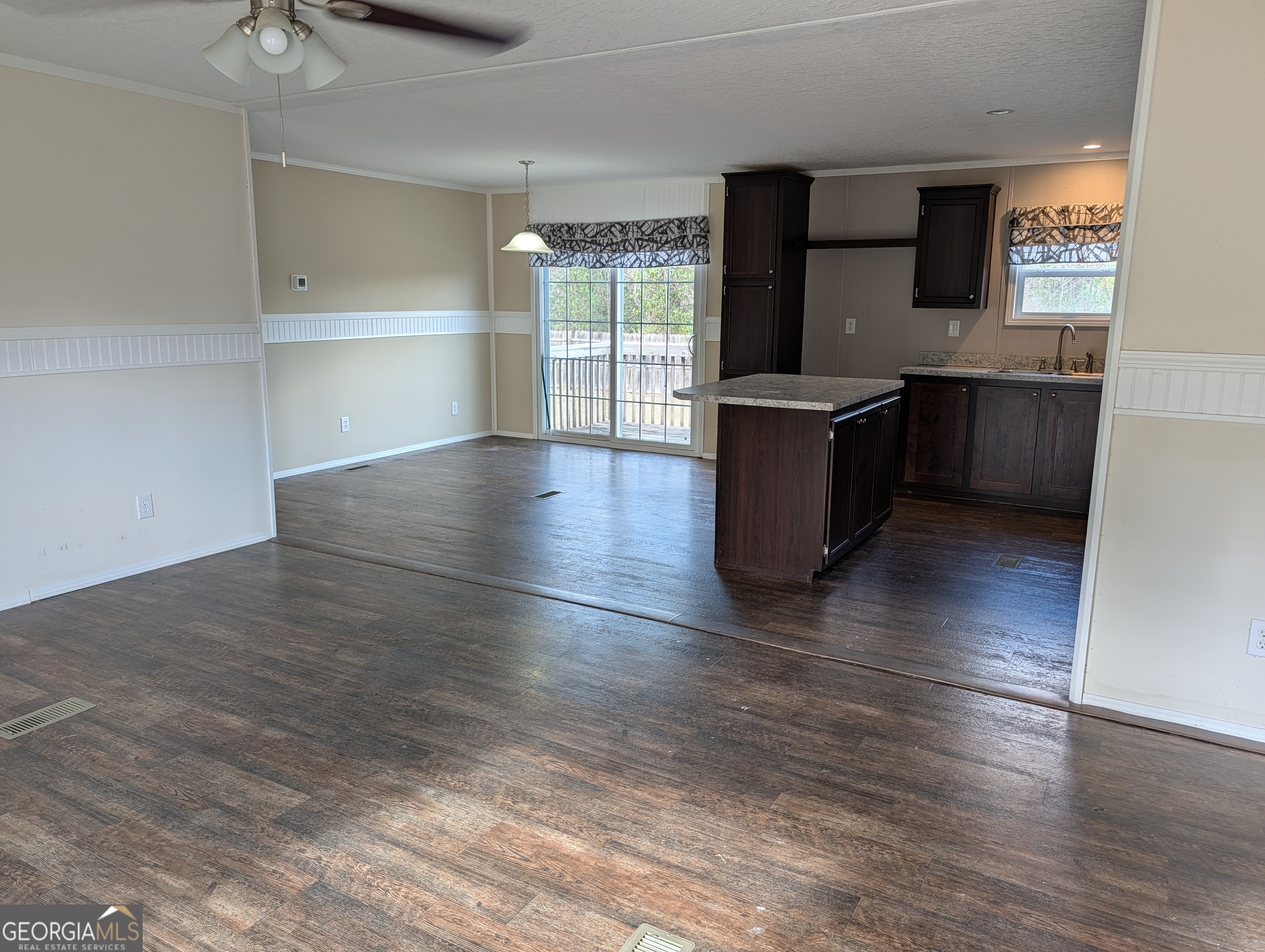 675 Fir Street Jesup, GA 31546 - Photo 9 of 22 an empty room with wooden floor and windows