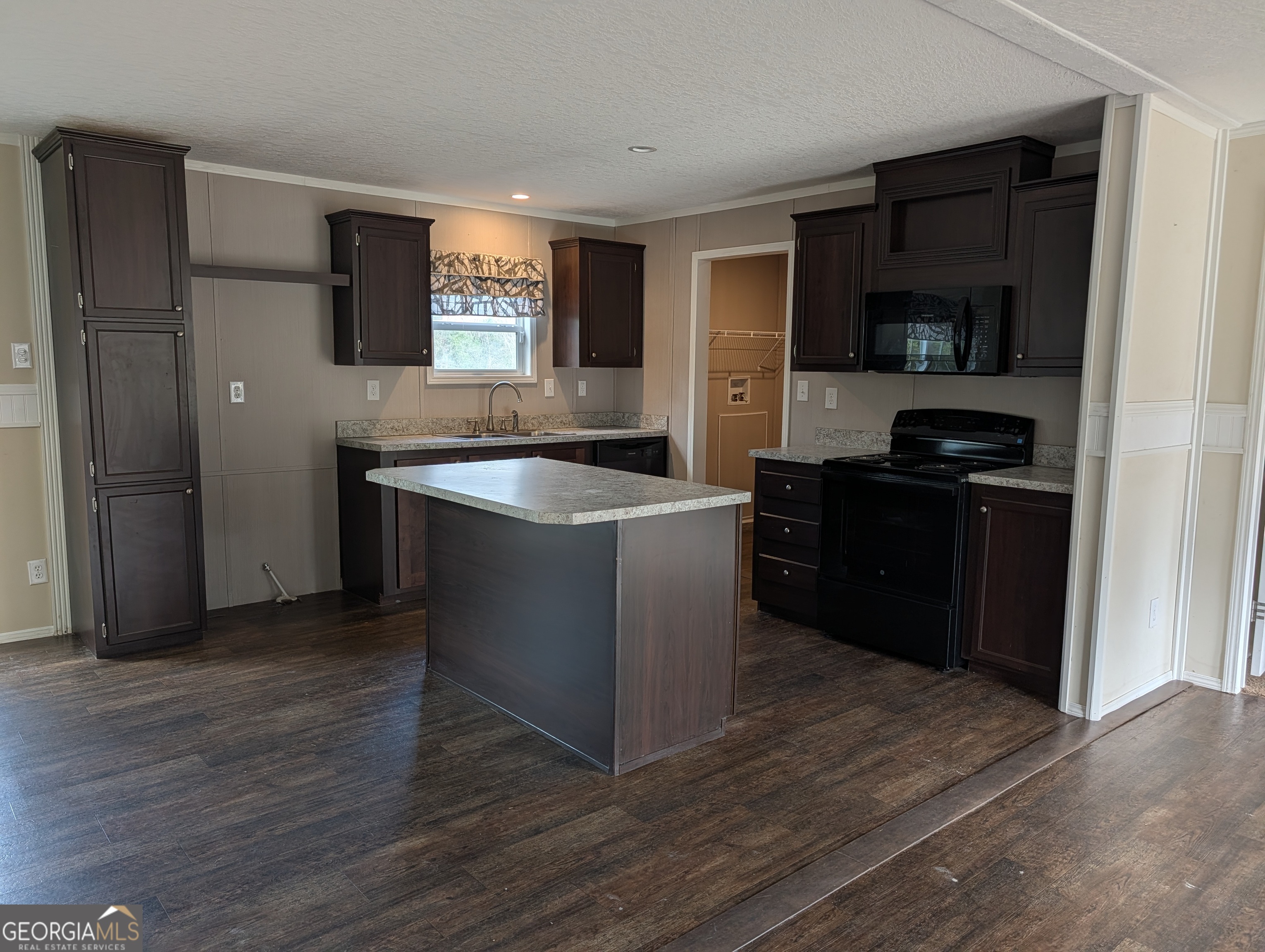 675 Fir Street Jesup, GA 31546 - Photo 10 of 22 a kitchen with stainless steel appliances granite countertop a sink and a refrigerator