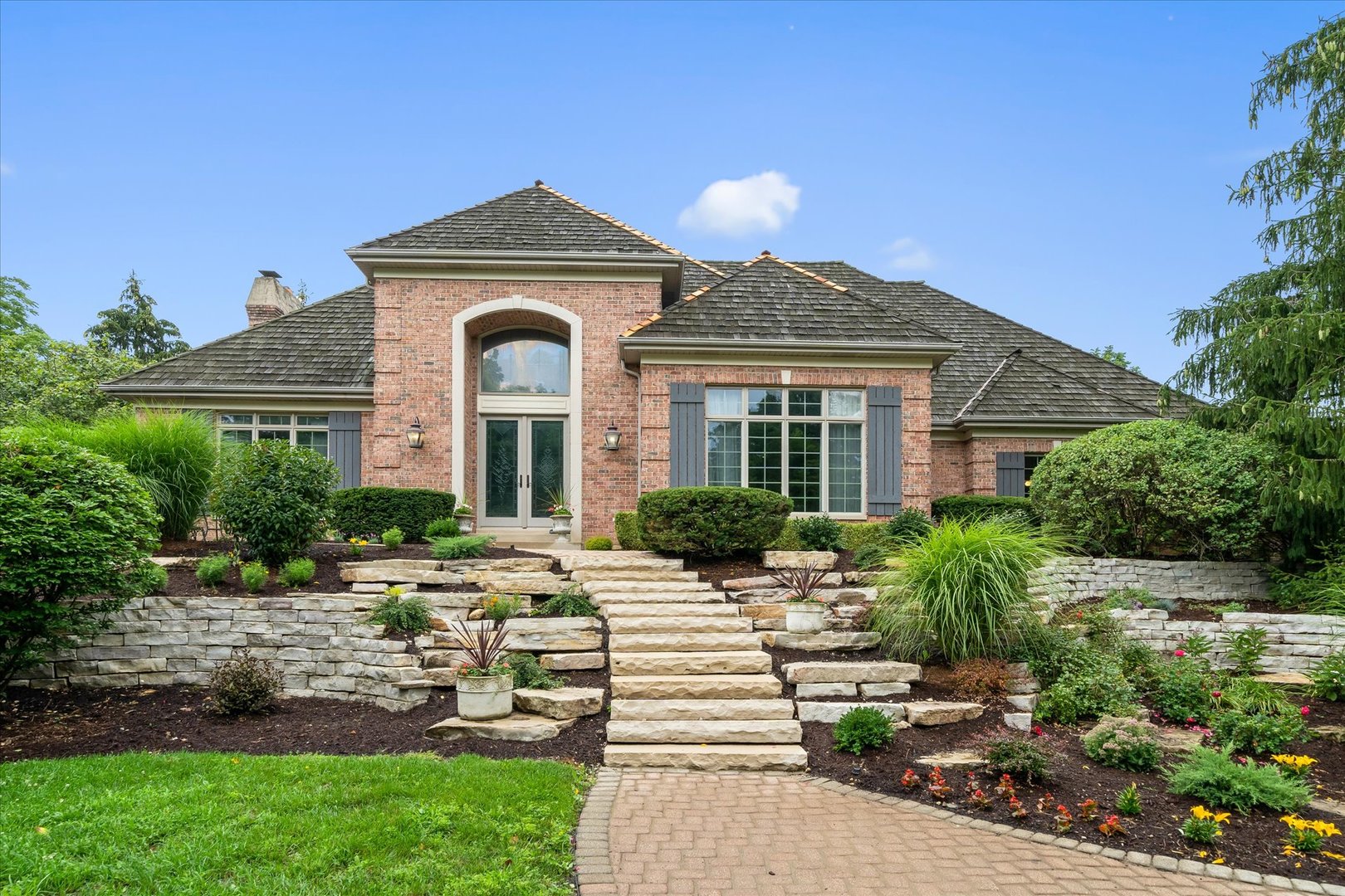 36W708 Stoneleat Road St. Charles, IL 60175 - Photo 1 of 31 a front view of a house with a garden
