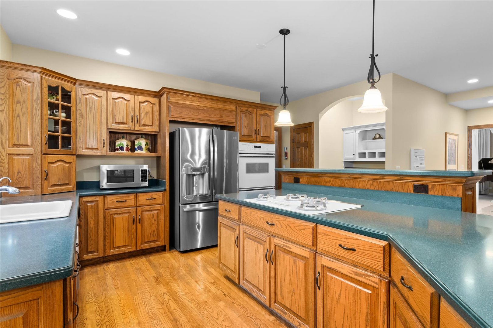 36W708 Stoneleat Road St. Charles, IL 60175 - Photo 7 of 31 a kitchen with stainless steel appliances granite countertop a sink a stove and refrigerator