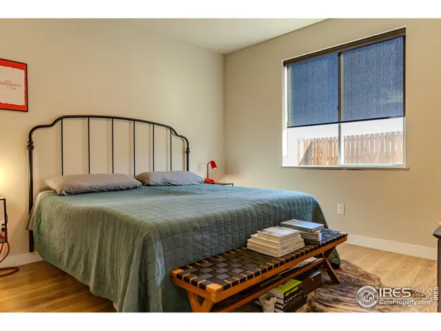 a bedroom with a bed window and a table