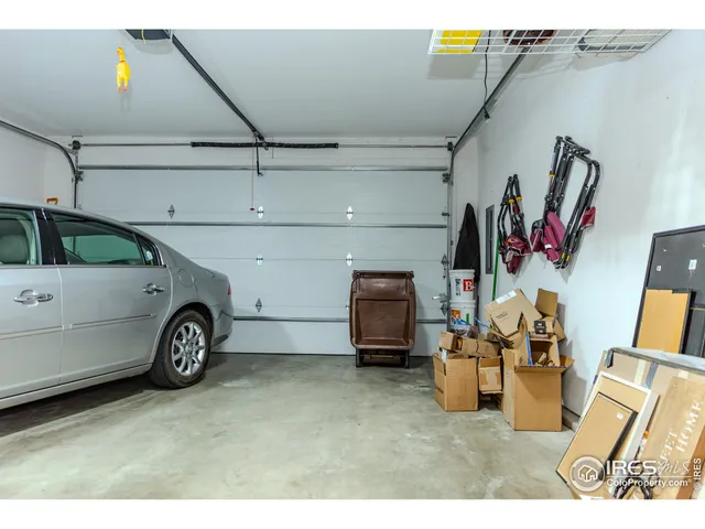 a view of a hallway with wooden floor and a door