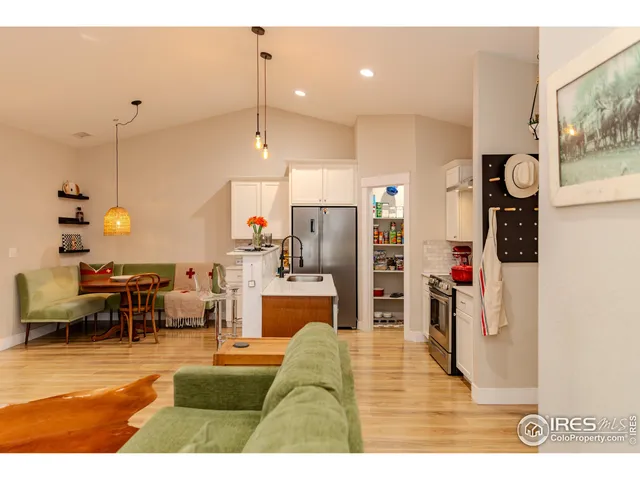 a living room with stainless steel appliances kitchen island granite countertop furniture and a view of living room