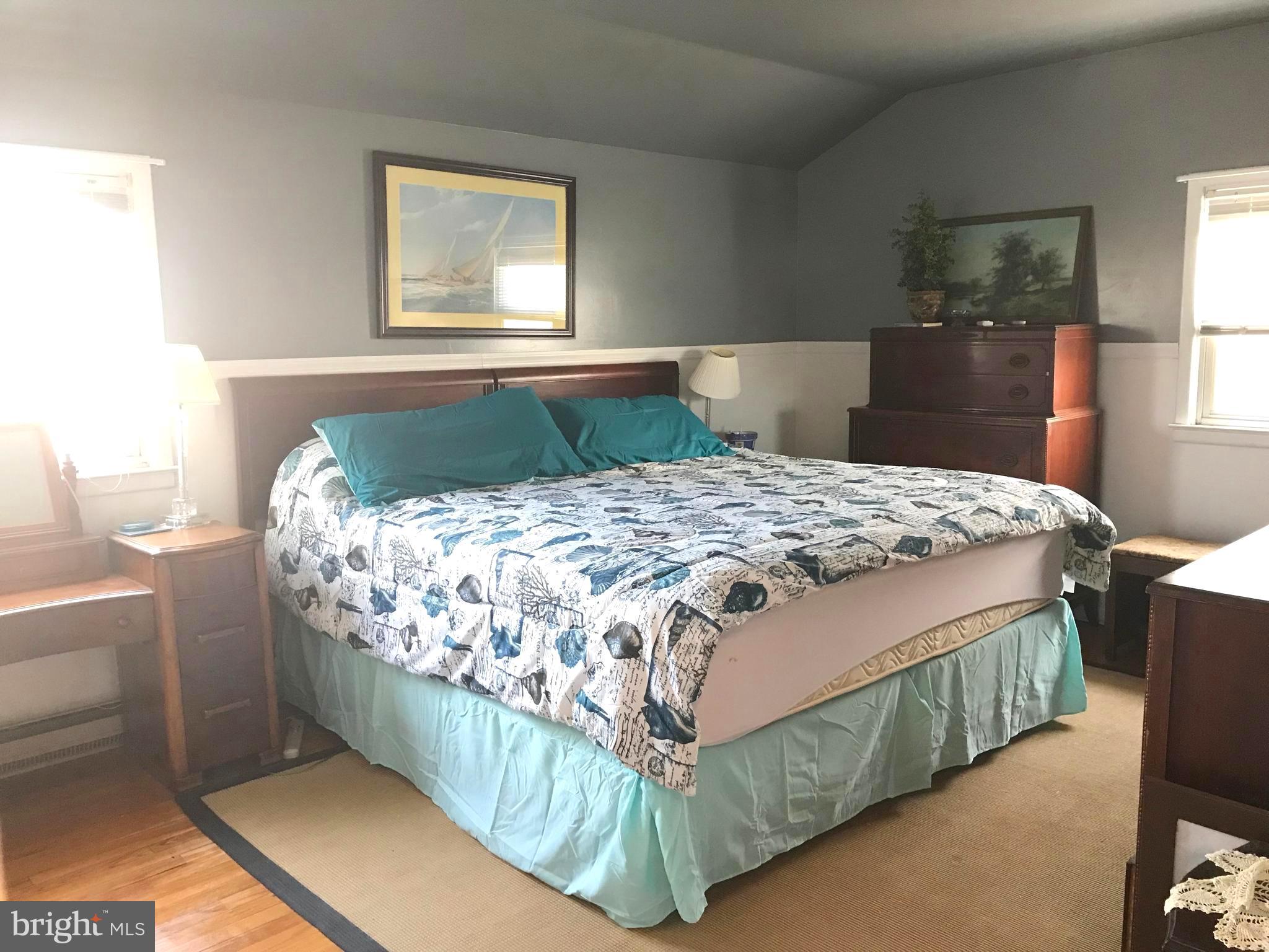 4416 Whalerman Road Brigantine, NJ 08203 - Photo 13 of 22 a bed sitting in a bedroom next to a window