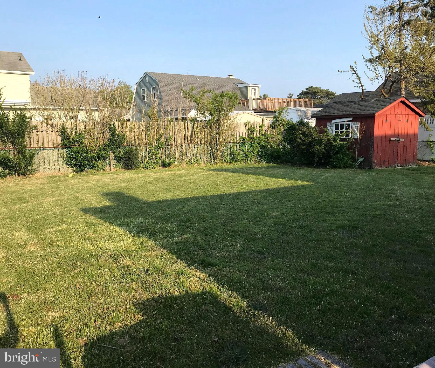 4416 Whalerman Road Brigantine, NJ 08203 - Photo 19 of 22 a view of a big yard with a house in the background