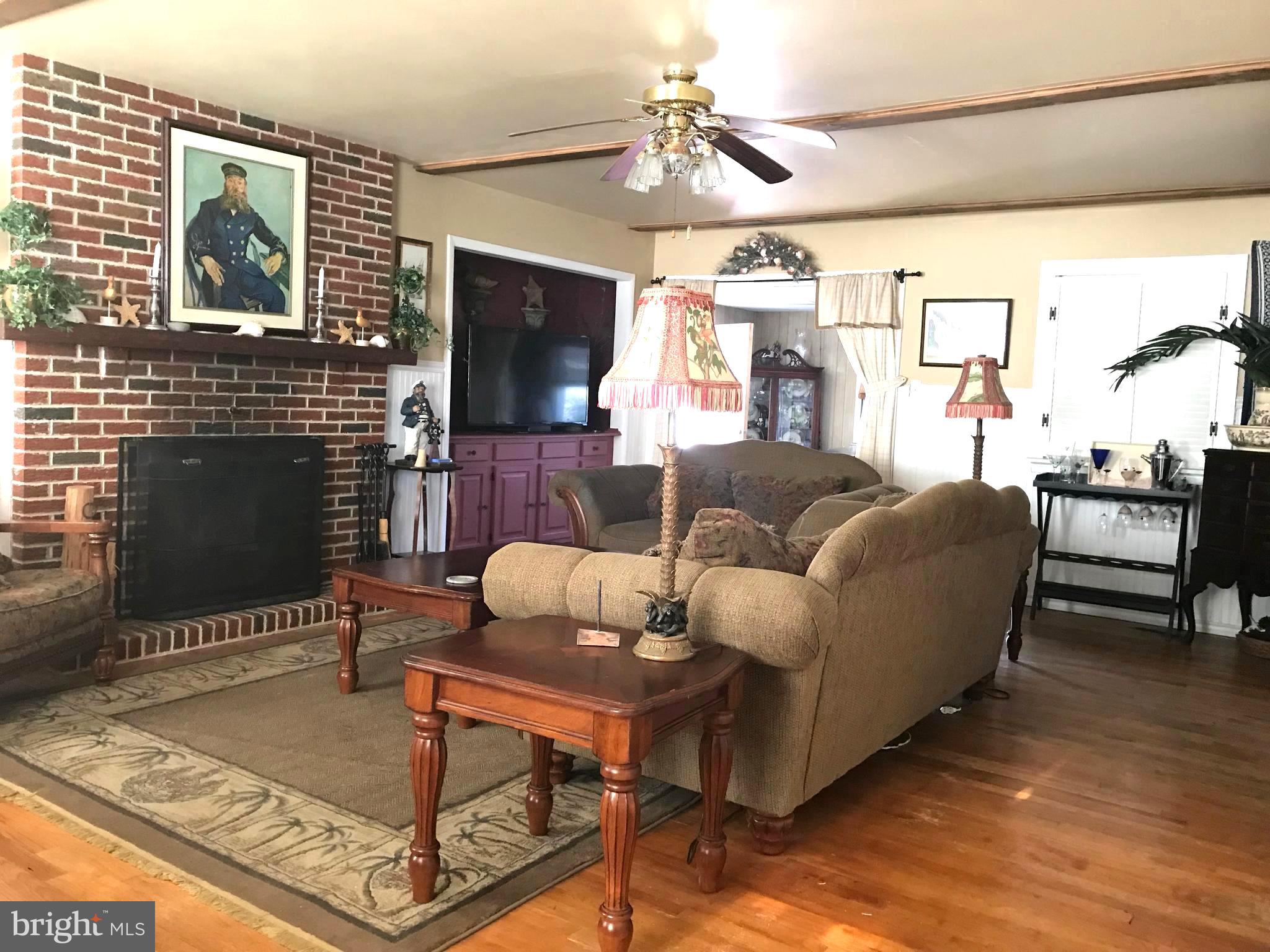 4416 Whalerman Road Brigantine, NJ 08203 - Photo 10 of 22 a living room with furniture a flat screen tv and a fireplace