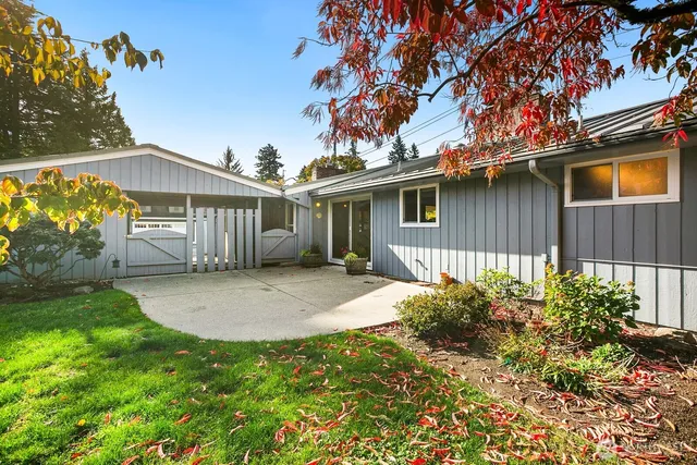 a view of a house with a yard and a garden