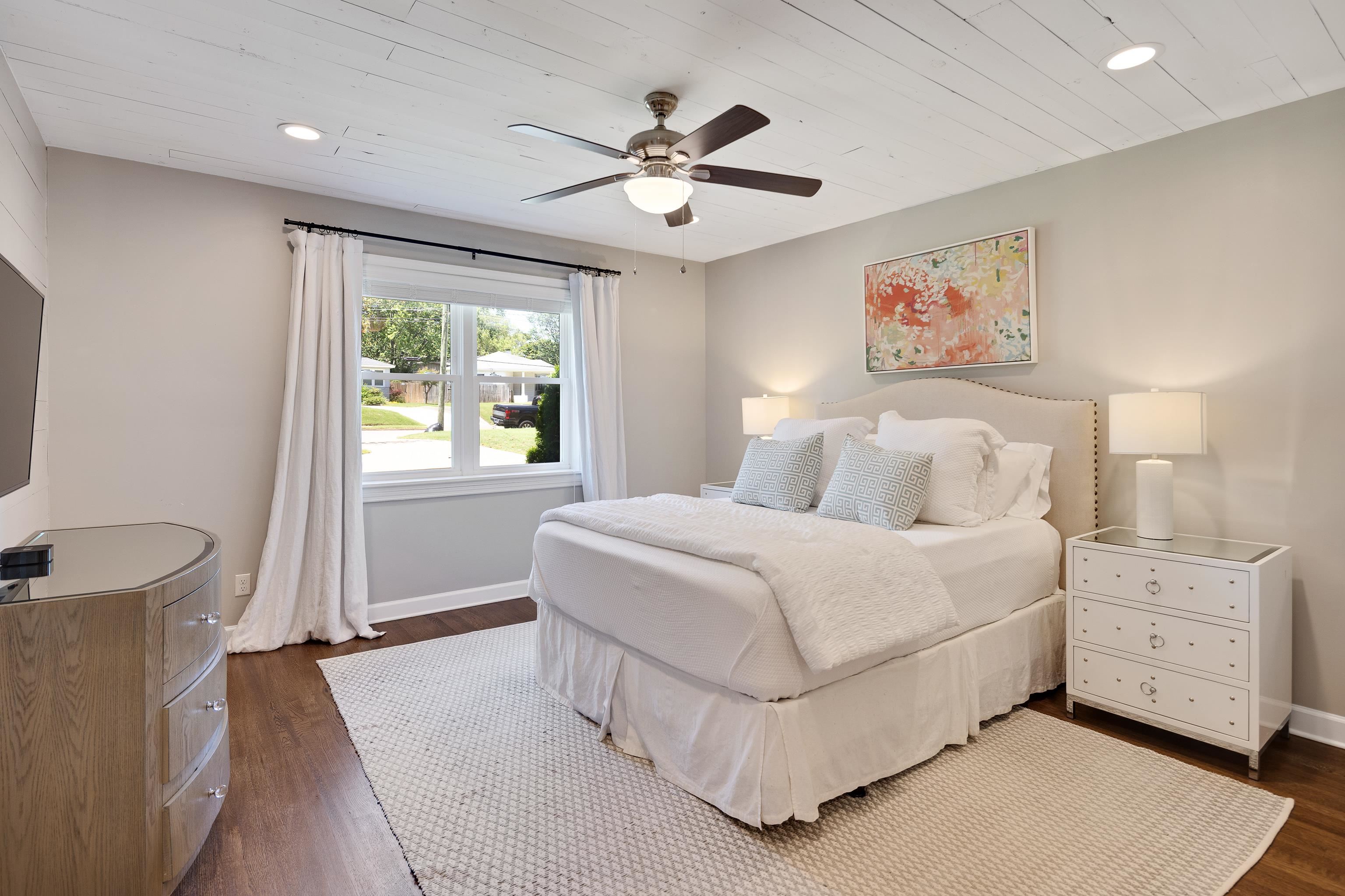 168 Avon Road Memphis, TN 38117 - Photo 18 of 38 a bedroom with a large bed and a chandelier