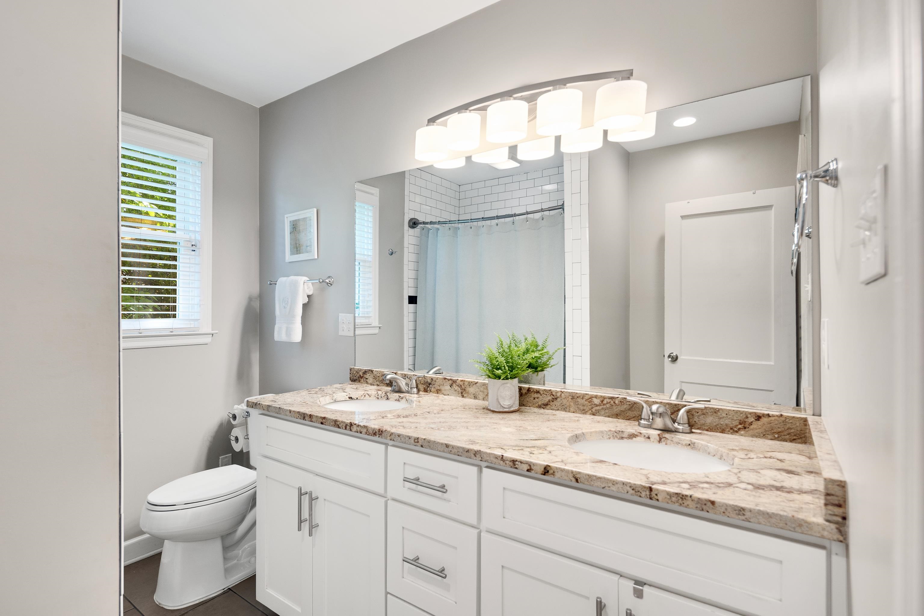 168 Avon Road Memphis, TN 38117 - Photo 30 of 38 a bathroom with a granite countertop sink vanity mirror and toilet