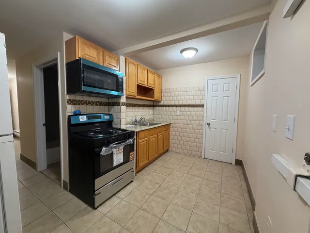 a kitchen with stainless steel appliances a refrigerator and a stove top oven