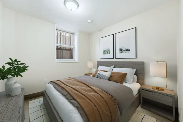 a bedroom with a bed and a potted plant