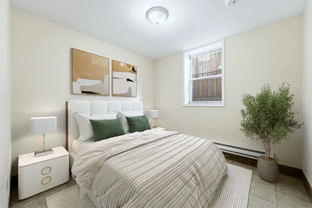 a bedroom with a bed and a potted plant