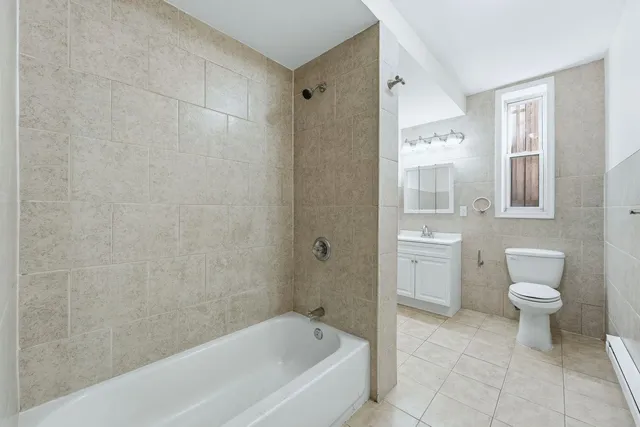 a bathroom with a bathtub toilet and sink