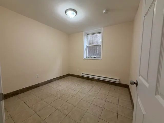 an empty room with a empty space and windows