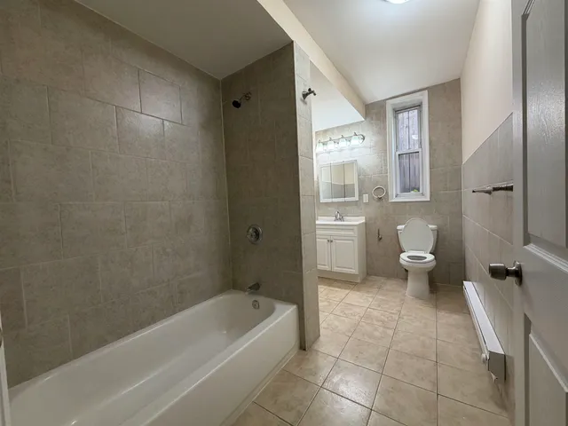 a bathroom with a bathtub a toilet and a shower