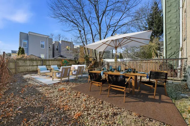 a view of a patio with a table and chairs under an umbrella