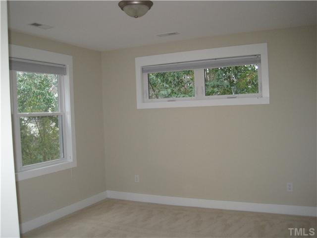 407 Glascock Street Raleigh, NC 27604 - Photo 17 of 25 Bedroom 3 features enough room for a queen bed, large fully accessible closet and lots of natural light. Bedroom