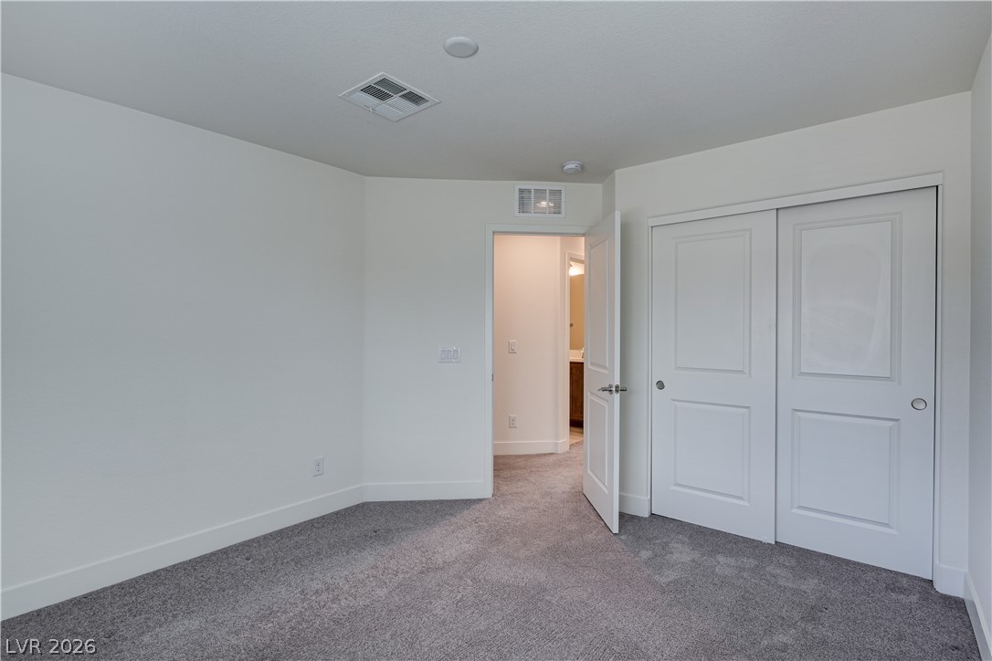 5954 Smith Valley Road Las Vegas, NV 89148 - Photo 19 of 23 An inviting bedroom features plush carpeting and convenient closet access.