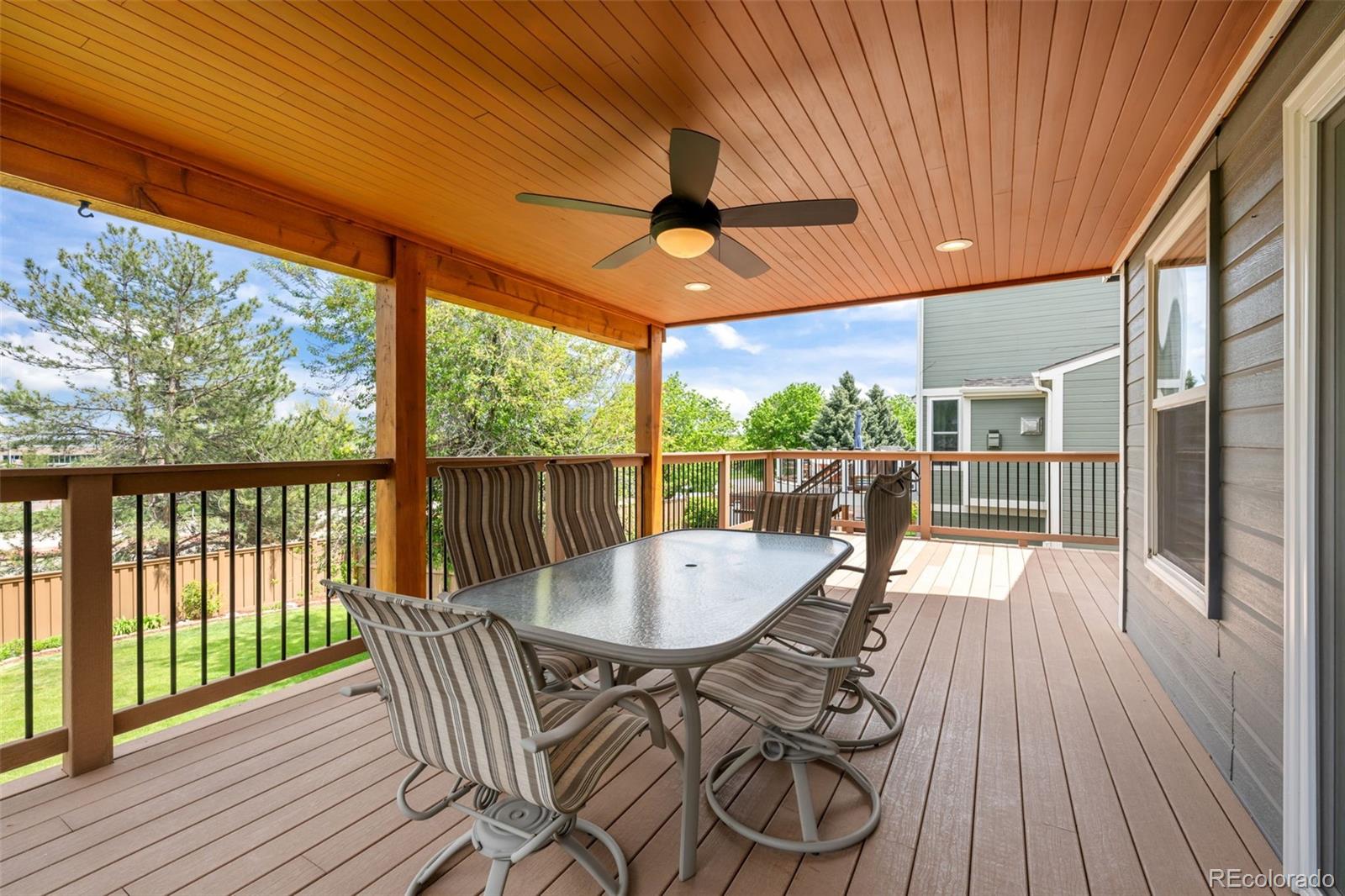 1735 Spring Water Lane Highlands Ranch, CO 80129 - Photo 26 of 50 a view of a patio with a table chairs and wooden floor