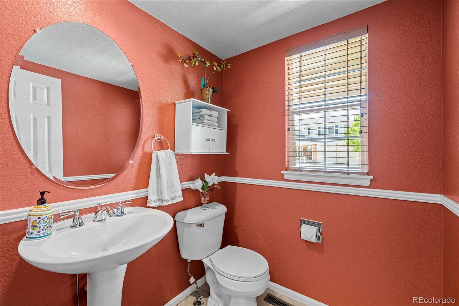 1735 Spring Water Lane Highlands Ranch, CO 80129 - Photo 27 of 50 a bathroom with a toilet a sink and a mirror