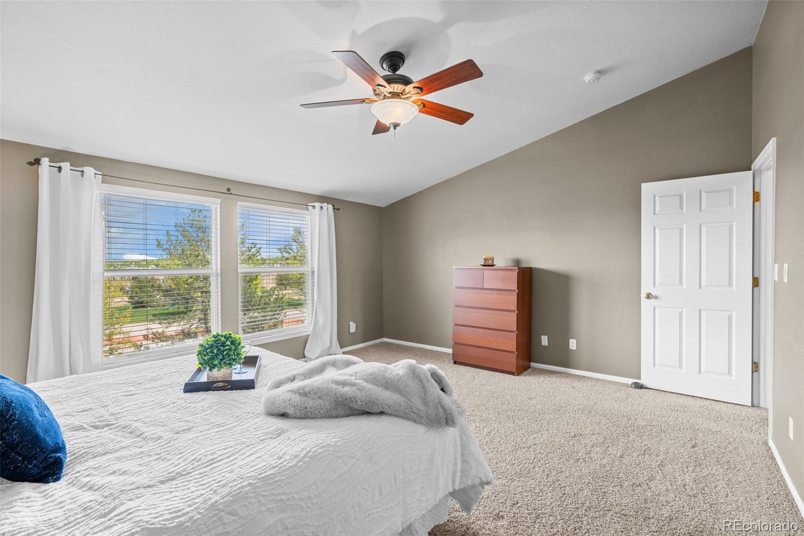 1735 Spring Water Lane Highlands Ranch, CO 80129 - Photo 31 of 50 a bedroom with a large bed and a large window