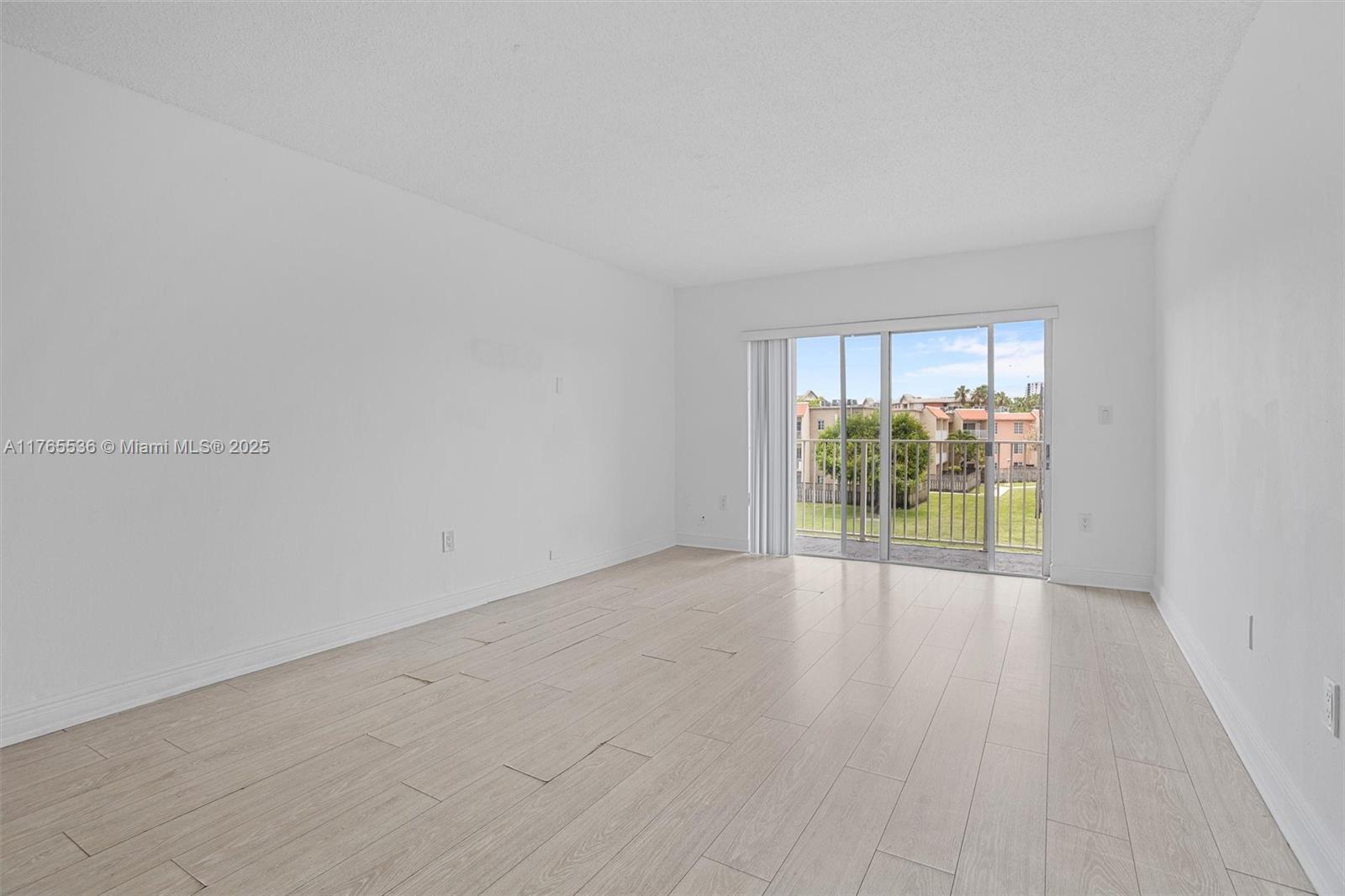 4920 Northwest 79th Avenue, Unit 309 Doral, FL 33166 - Photo 11 of 33 wooden floor in an empty room with a window
