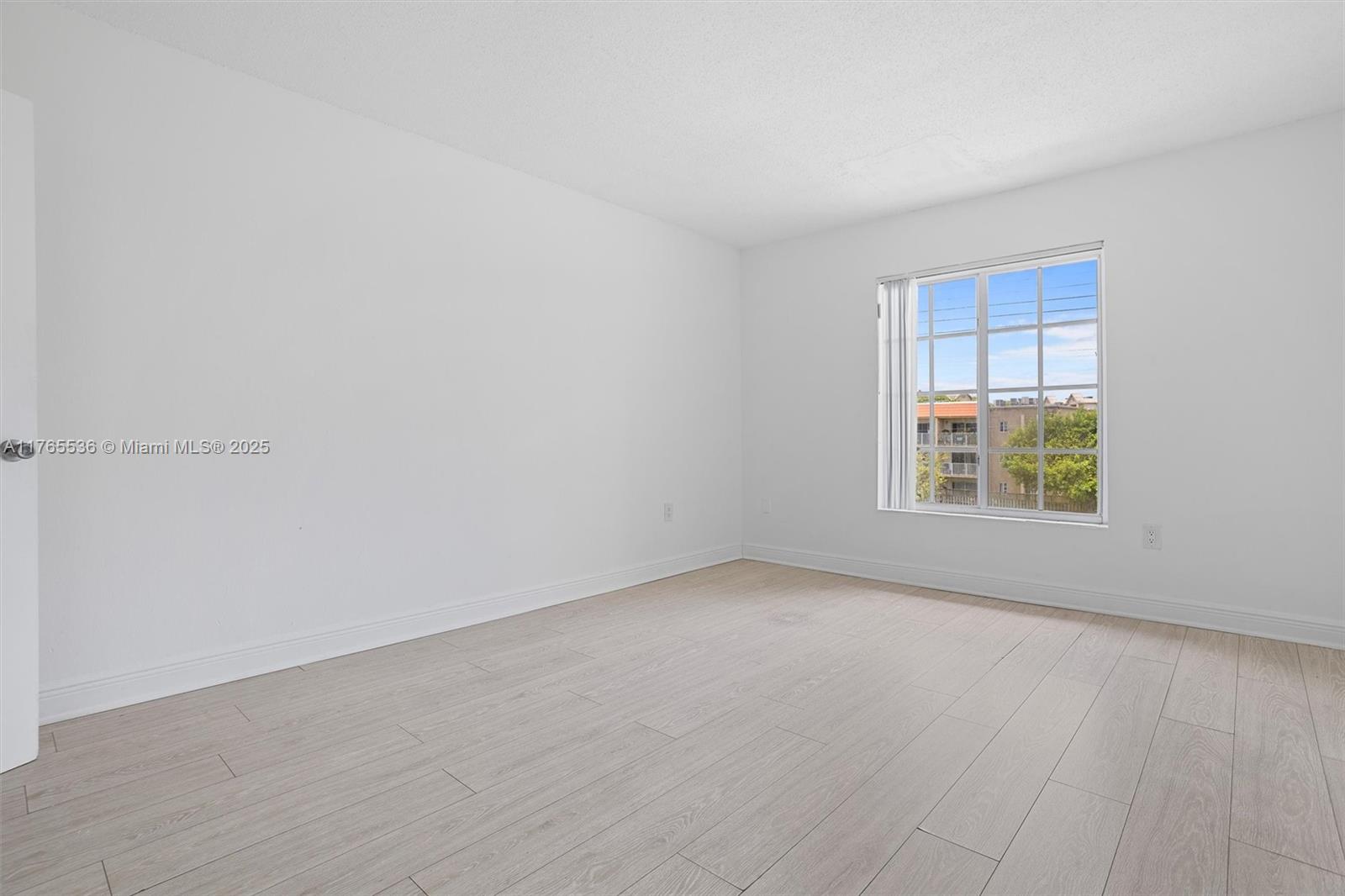 4920 Northwest 79th Avenue, Unit 309 Doral, FL 33166 - Photo 15 of 33 a view of an empty room with a window