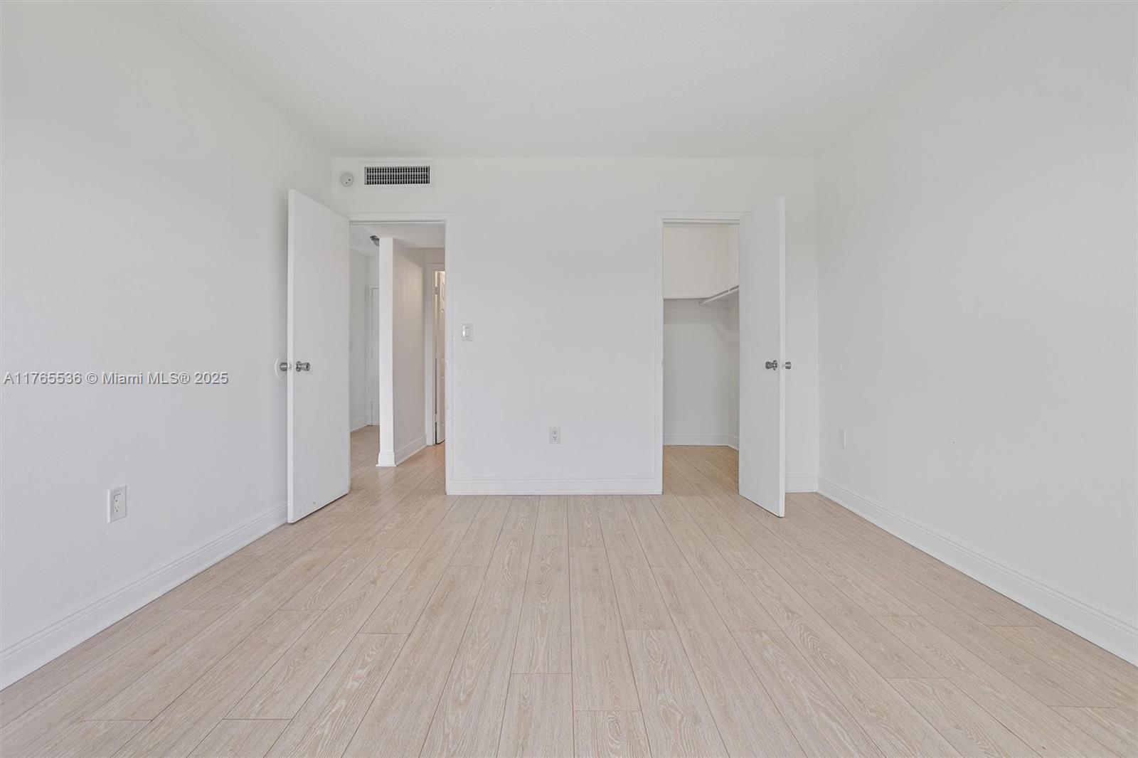 4920 Northwest 79th Avenue, Unit 309 Doral, FL 33166 - Photo 16 of 33 a view of an empty room with wooden floor